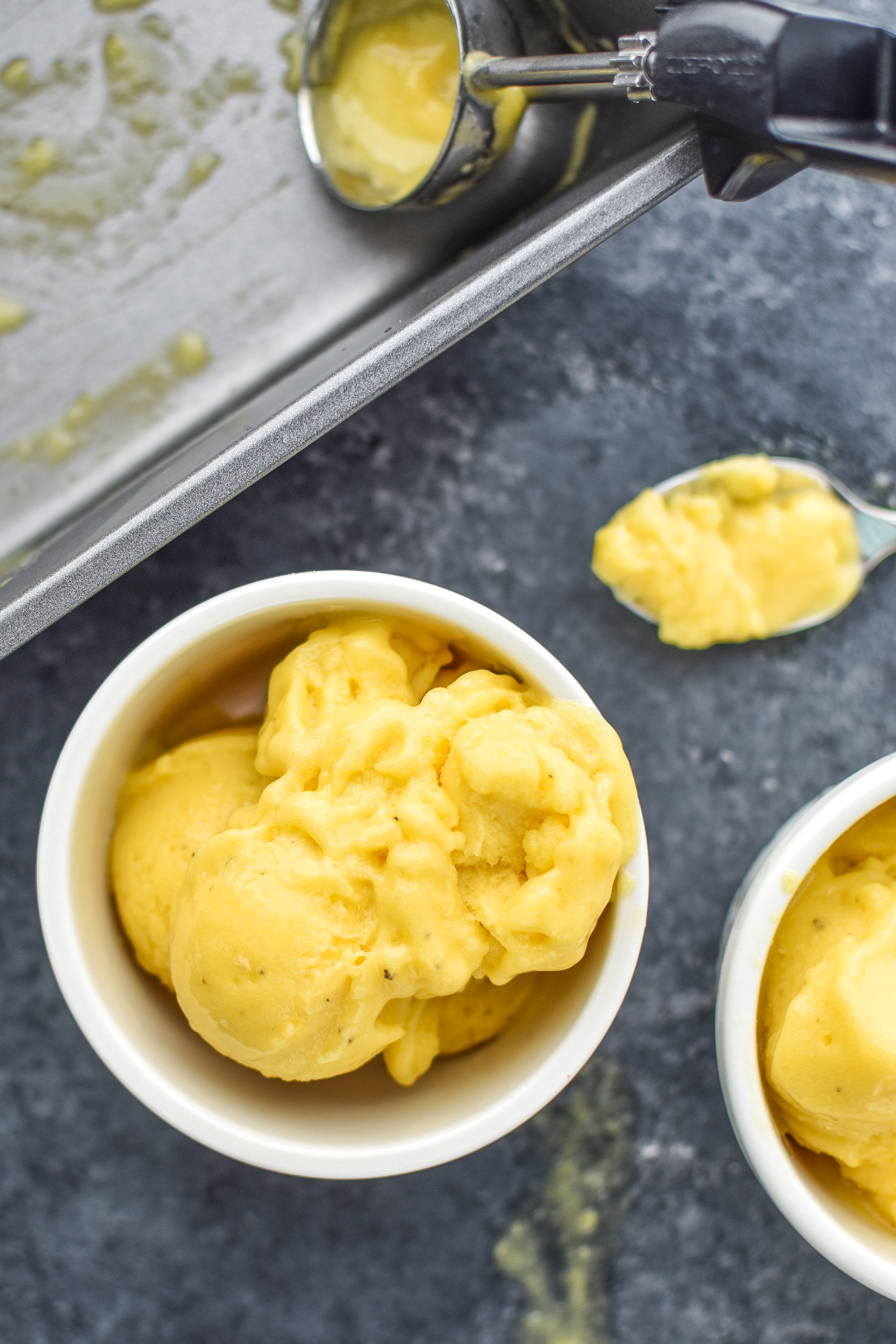 A bowl of mango lime nice cream after being scooped from the loaf pan.
